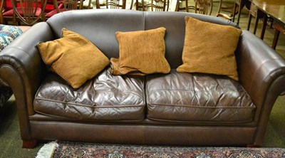 Lot 1324 - A large two seater leather sofa by Derwent Upholstery