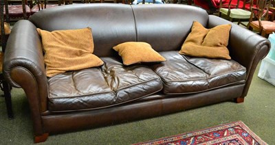 Lot 1329 - A large three seater leather sofa by Derwent Upholstery