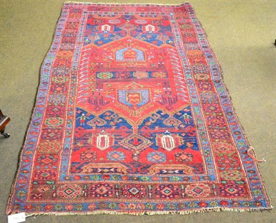 Lot 1343 - A Bidjar rug, Persian Kurdistan, the indigo field centred by a crimson panel framed by borders...