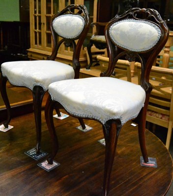 Lot 1355 - A pair of Victorian walnut framed side chairs