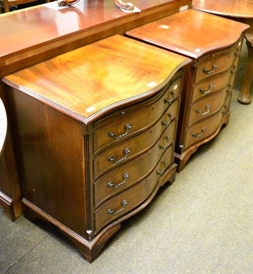 Lot 1356 - A pair of reproduction serpentine fronted four height chests of drawers with brush slides