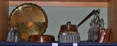 Lot 85 - A shelf of copper and brass including moulds and a plated condiment stand with glass jars