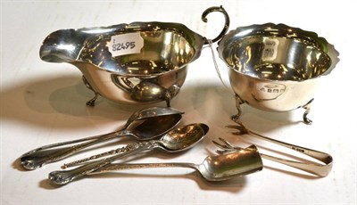Lot 122 - A silver sauce boat, a silver sugar bowl, silver tongs, four silver spoons and a shovel