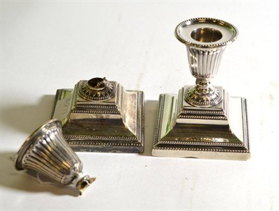 Lot 164 - A pair of late Victorian silver dwarf candlesticks, loaded, London 1877 (a.f.)