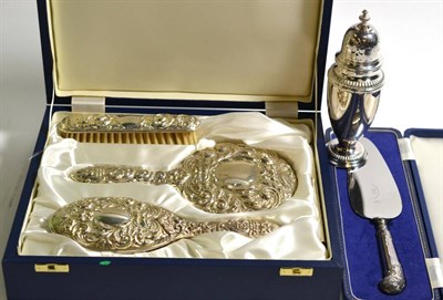Lot 180 - A Mappin & Webb silver caster, a silver handled cake knife and a silver backed three piece dressing