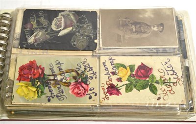 Lot 187 - An album of mixed postcards including embroidered silks, real photographic and printed