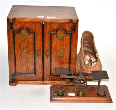 Lot 225 - An oak smokers cabinet, another cabinet, cigars, set of postal scales and a bag of clay pipes