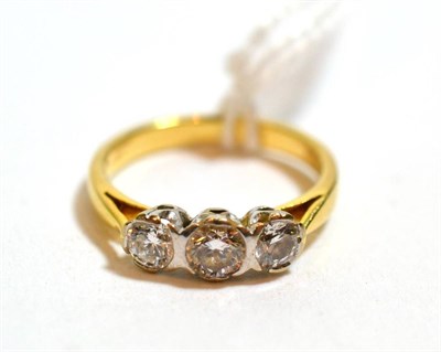 Lot 265 - An 18ct yellow gold three stone diamond ring, brilliant cut, approximately 0.68 carat in total