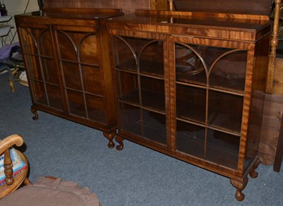 Lot 1014 - A pair of early 20th century walnut and mahogany display cabinets