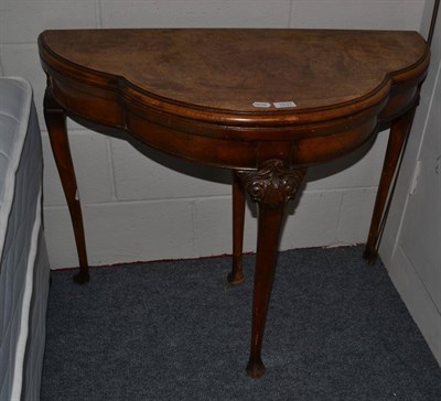 Lot 1037 - Walnut veneer fold over card table