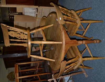 Lot 1051 - A circular pine table, turned legs together with a set of four pine dining chairs, pierced...