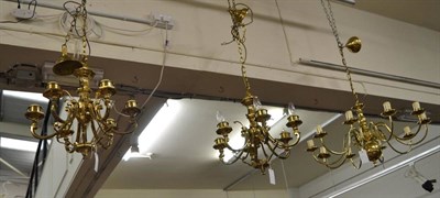 Lot 1070 - A brass standard lamp and a pair of chandeliers and another