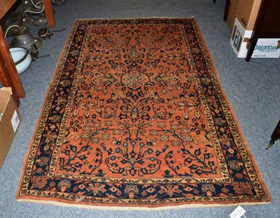 Lot 1073 - Saroukh rug, West Persia, the rust ground with flowering boughs enclosed by indigo borders of...