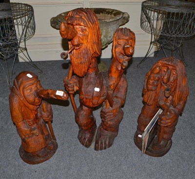 Lot 1075 - Three Norwegian large carved wood figures of trolls with associated letters and related book