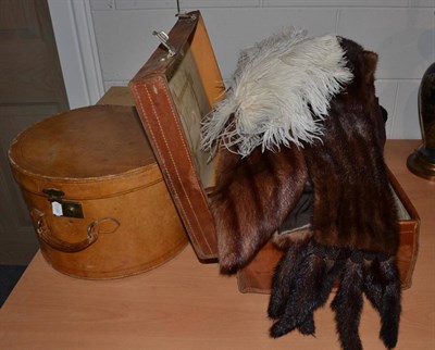 Lot 1080 - A grey top hat and gloves, a black top hat and a suitcase full of linen, furs, etc