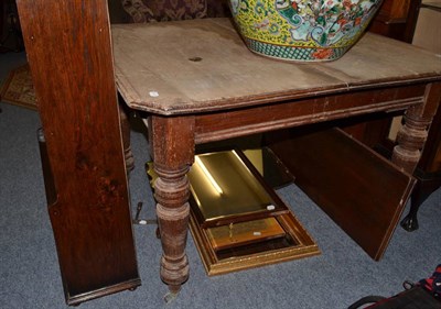 Lot 1113 - Victorian extending dining table with leaf and winding key, together with an oak open bookcase,...