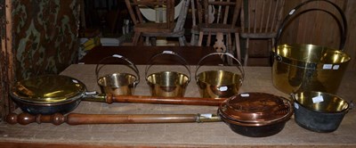 Lot 1123 - Two warming pans, five brass pans and a steel pan stand