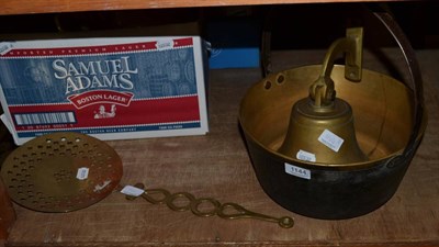 Lot 1144 - A brass bell, jam pan and a brass cream skimmer (3)