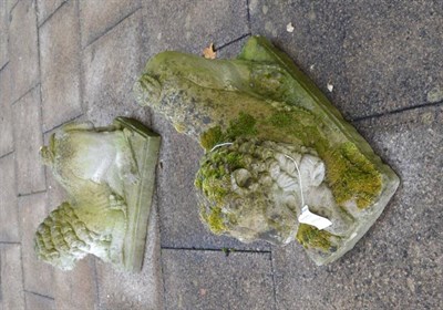 Lot 1159 - A pair of reconstituted recumbent lion garden ornaments