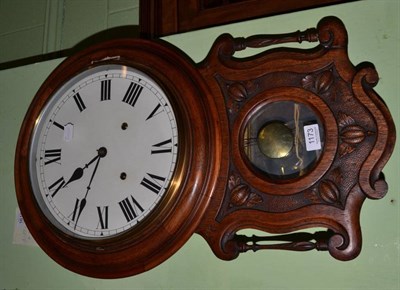 Lot 1173 - A carved oak and mahogany drop dial wall clock