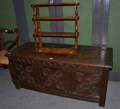 Lot 1174 - An 18th century carved oak linen chest and a shelf rack