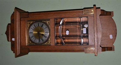 Lot 1176 - An oak wall clock