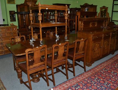 Lot 1198 - Early 20th century carved oak nine piece dining room suite comprising sideboard, table, six...