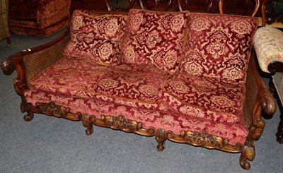 Lot 1235 - An early 20th century mahogany bergere settee, carved acanthus scroll arms, pierced apron,...