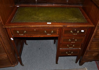 Lot 1252 - An Edwardian mahogany desk of asymmetrical form, gilt tooled green leather inset single frieze...