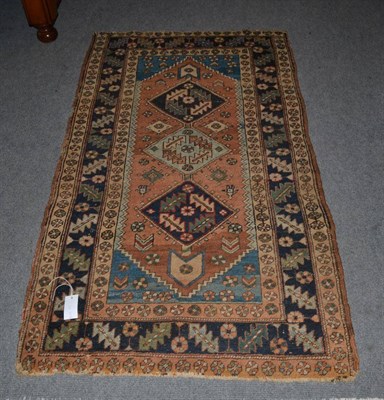 Lot 1257 - Heriz rug, Iranian Azerbaijan, the terracotta lozenge field with three diamond medallions...