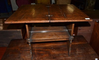 Lot 1258 - An early 20th century oak fold-over swivel top table