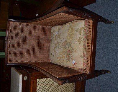 Lot 1297 - George IV mahogany caned squared bergere, with squab