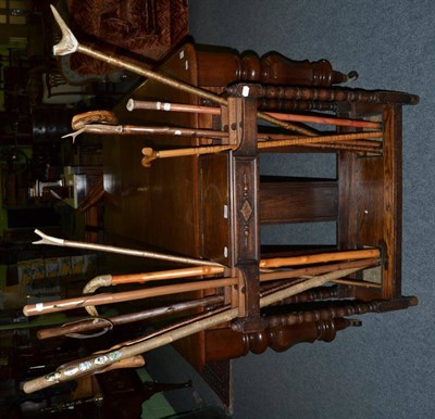 Lot 1301 - An oak stick stand and a quantity of walking sticks