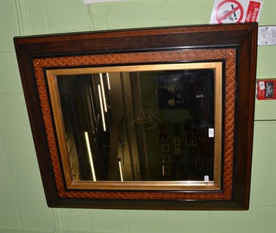 Lot 1305 - A large rectangular wall mirror with mixed wood parquetry frame