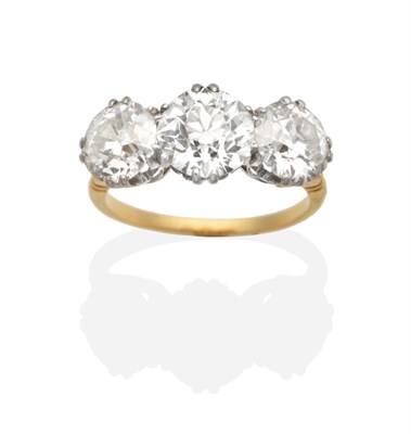 Lot 184 - A Diamond Three Stone Ring, graduated old cut diamonds in double claw settings, to forked...