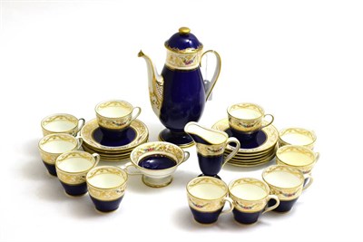 Lot 7 - A Royal Doulton coffee set decorated with floral swags on a cobalt blue ground, eleven cups and...