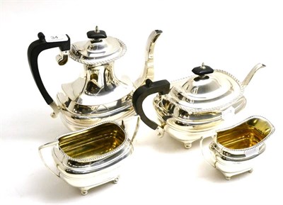 Lot 34 - A four piece silver Walker and Hall tea service, the tea and hot water with ebony handles