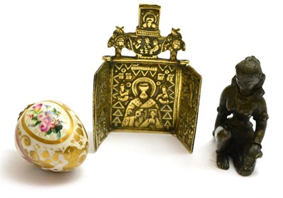 Lot 80 - A porcelain 'Egg' bell pull, a brass tryptic and a bronze figure