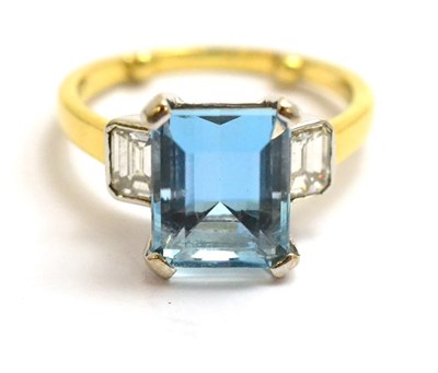 Lot 92 - An aquamarine and diamond three stone ring, the emerald-cut aquamarine between an emerald-cut...