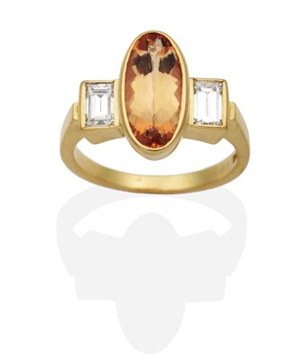 Lot 201 - An 18 Carat Gold Imperial Topaz and Diamond Three Stone Ring, an oval cut imperial topaz in a...
