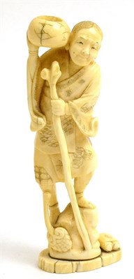 Lot 135 - A Japanese ivory Okimono, Meiji period, of a sage holding a gourd to his ear, scrolls lying at...