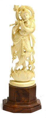 Lot 136 - An Indian carved ivory figure of Padmapani, in typical pose, playing a pipe, standing on a...