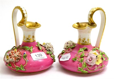 Lot 139 - A pair of Crown Derby porcelain ewers circa 1825-40, with puce bodies and floral decoration,...