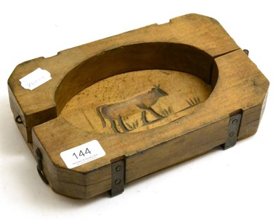 Lot 144 - A wooden butter mould with cow impression