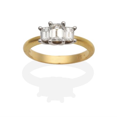 Lot 205 - An 18 Carat Gold Diamond Three Stone Ring, graduated octagonal cut diamonds in claw settings to...
