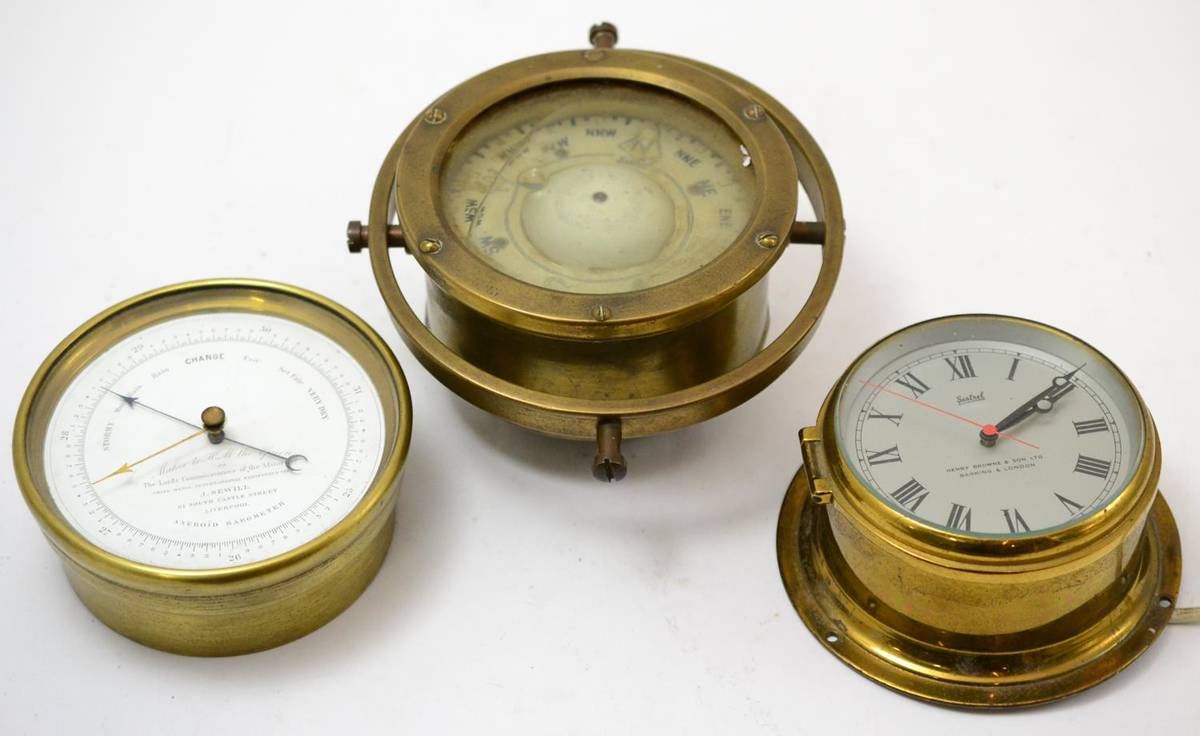 Lot 186 - A brass cased Sestrel compass mounted on a gimbal together with a brass cased ships barometer,...