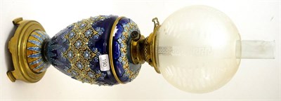 Lot 190 - A Doulton Lambeth stoneware oil lamp with etched glass shade, 63cm high including chimney