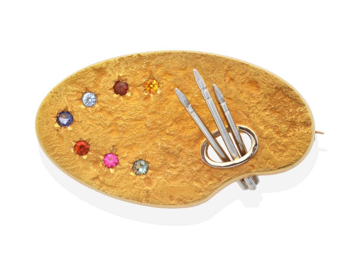 Lot 207 - A Multi-Gemstone Artist's Palette Brooch, a textured palette with three paint brushes and star...