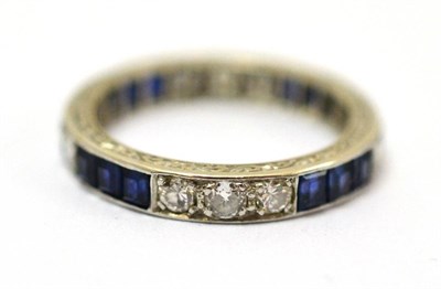 Lot 242 - A sapphire and diamond eternity ring