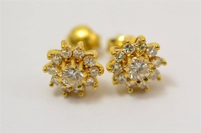 Lot 254 - A pair of diamond cluster earrings, a round brilliant cut diamond within a border of eight-cut...